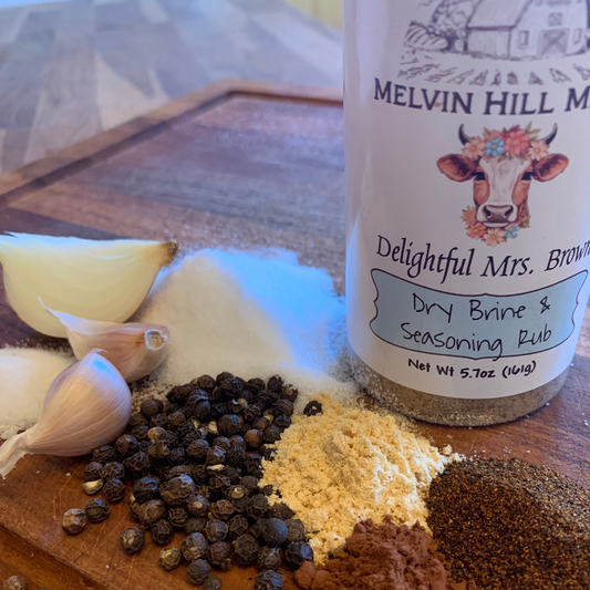 seasoning ingredients on cutting board with bottle of seasoning