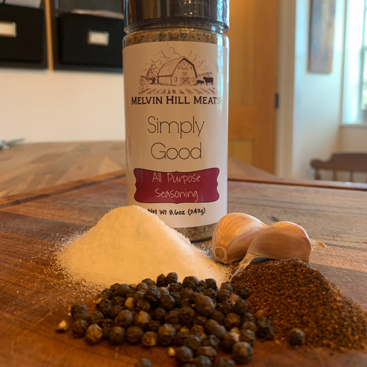 Simply Good seasoning blend bottle with raw ingredients on cutting board
