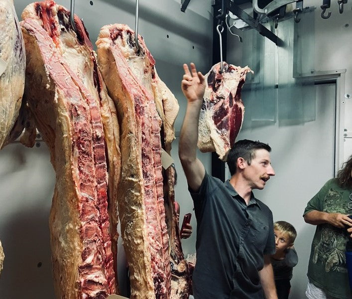 Butcher shop owner and head butcher gives a tour with real, local Polk County, NC beef available near Tryon, Columbus, Landrum, Boiling Springs.